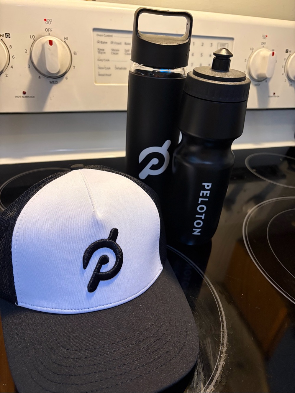 Peloton Black & White Logo Trucker Hat with Black Peloton Water Bottles